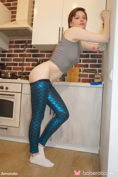 Amanda is in a fun mood as she gets naked in the kitchen for us in VR gallery