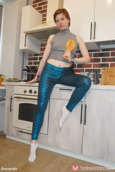 Amanda is in a fun mood as she gets naked in the kitchen for us in VR gallery