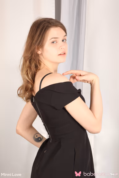 Minni Love is dressed all in black showing off her sexy tits and ass in VR gallery